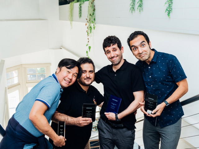 group of men holding trophies