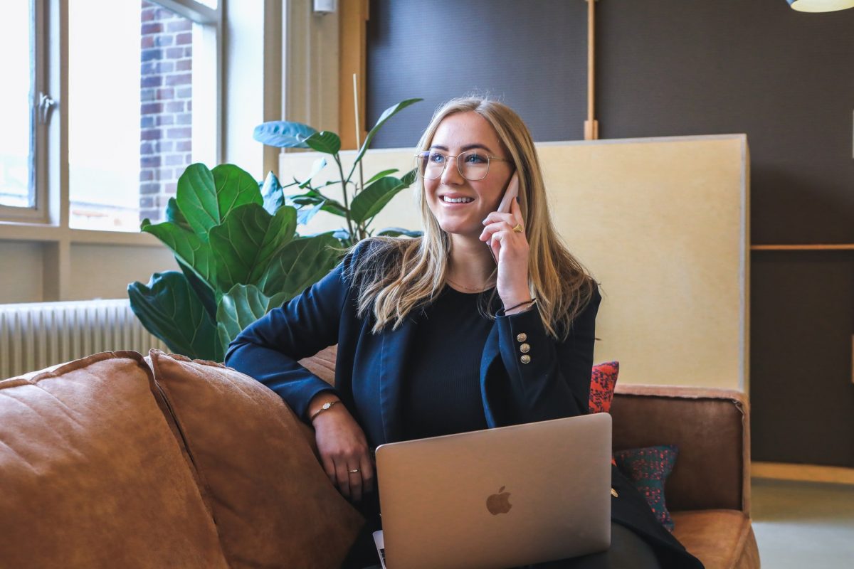 woman on phone to customer service smiling